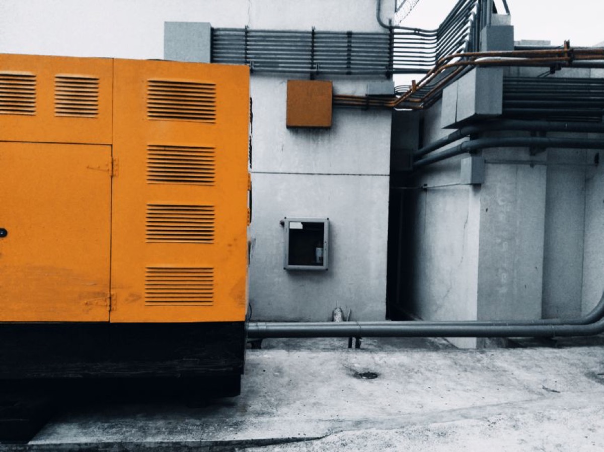 Portable generator positioned outside for home backup power with control panel and outlets visible