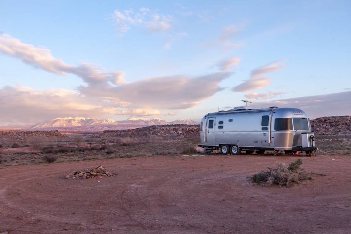 Travel trailer in remote desert landscape requiring off-grid generator power for extended boondocking