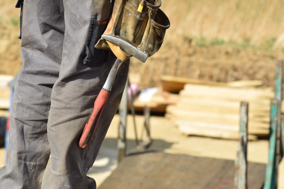 Construction worker using power tools on a residential jobsite