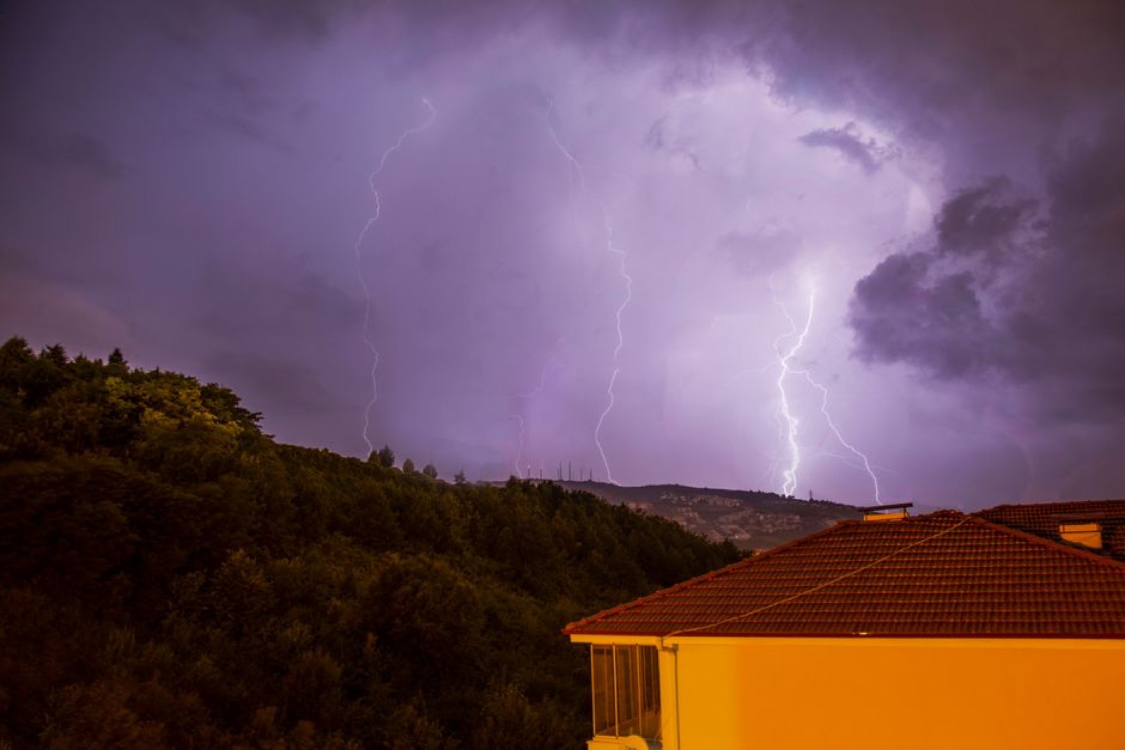 Modern home exterior during storm conditions requiring backup power system