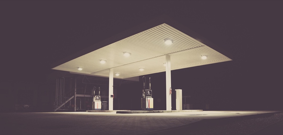 Nighttime gas station illuminated - fueling up fresh gasoline for seasonal generator startup