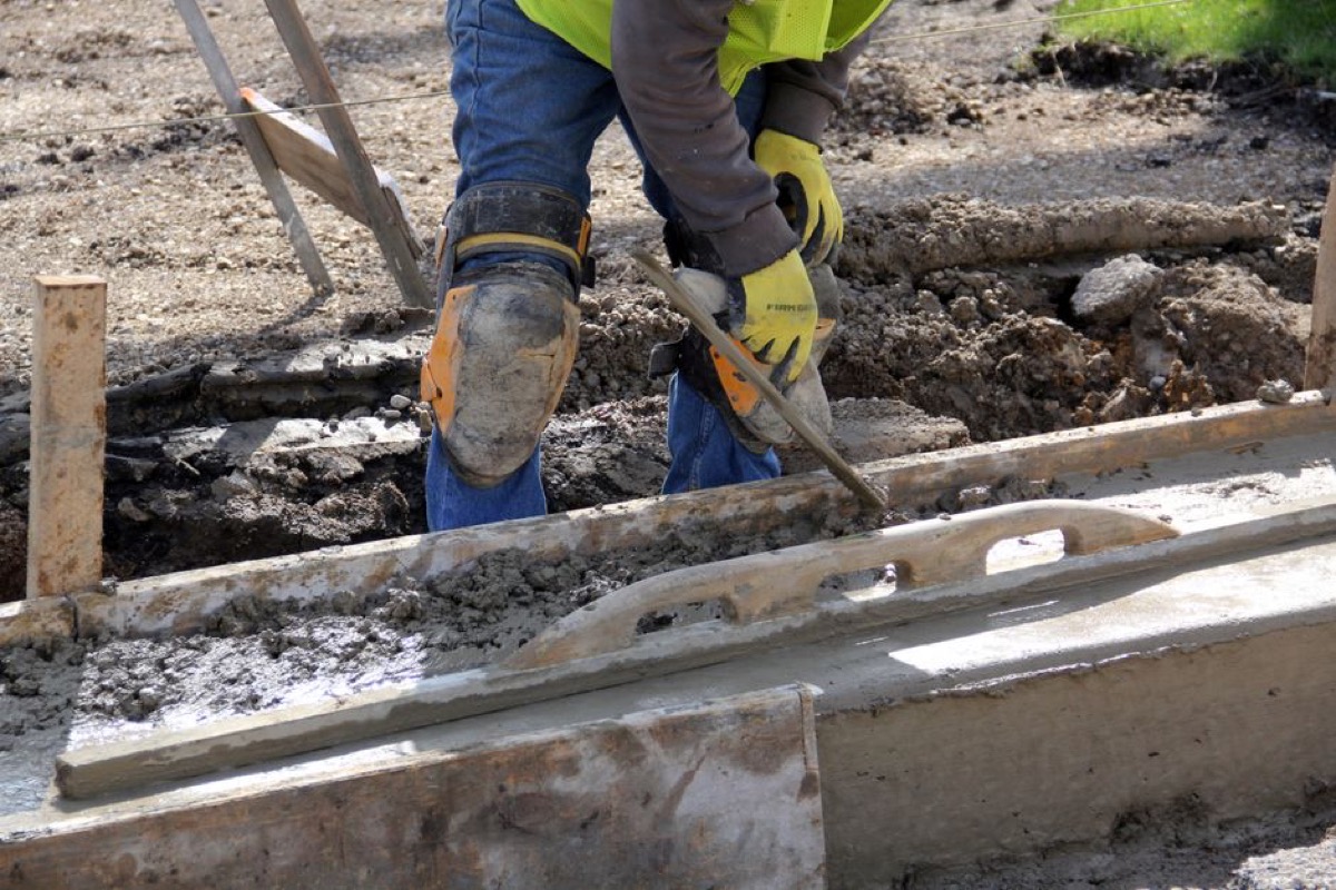 Construction worker using hand tools at outdoor jobsite