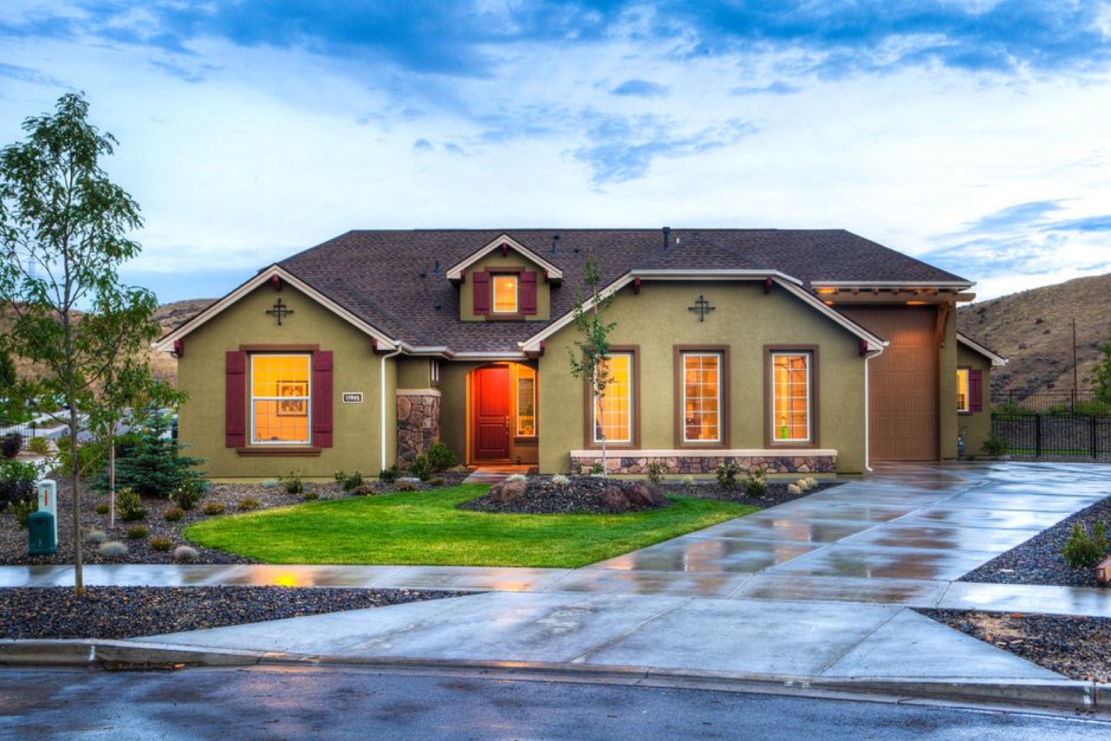 Modern home exterior with clean driveway where a portable dual-fuel generator would provide backup power