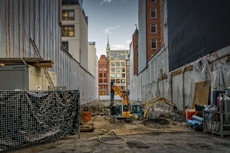 Heavy equipment construction site with excavators and machinery showing active jobsite power needs