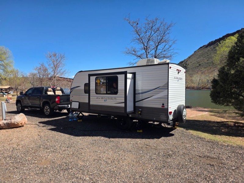 Travel trailer motorhome at night with interior lights on during evening camping requiring portable power